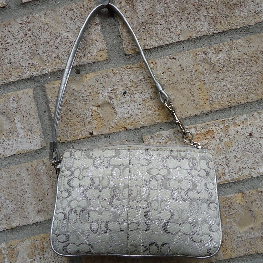 Coach wristlet with classic signature print canvas.